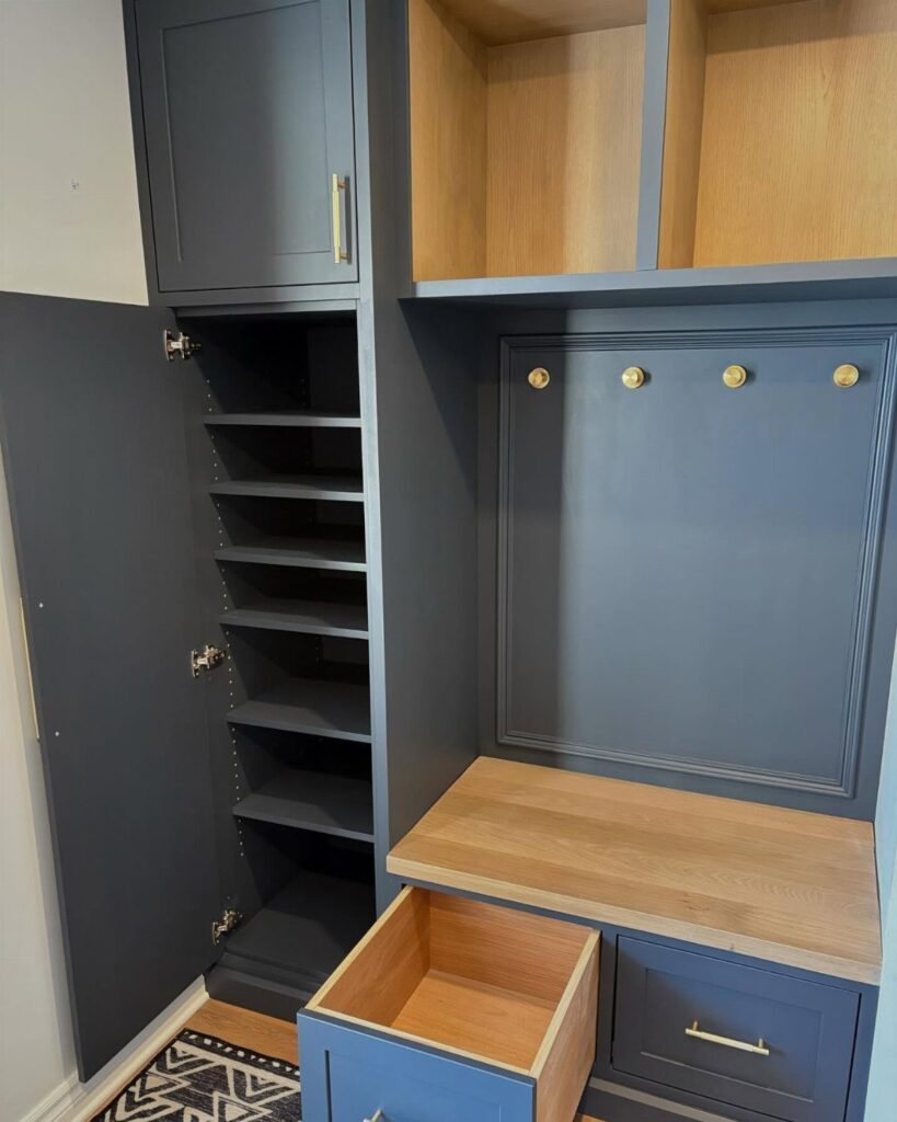Dark blue built-in hall tree with light wood accents and integrated storage shelves.