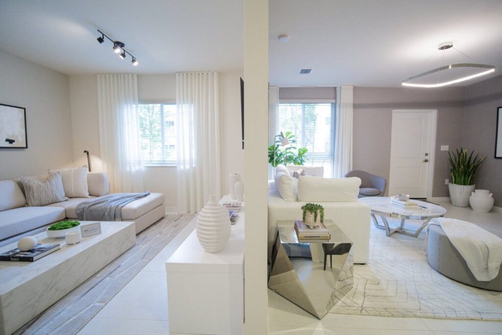 White sheer curtains hanging from ceiling to floor in a modern white apartment.