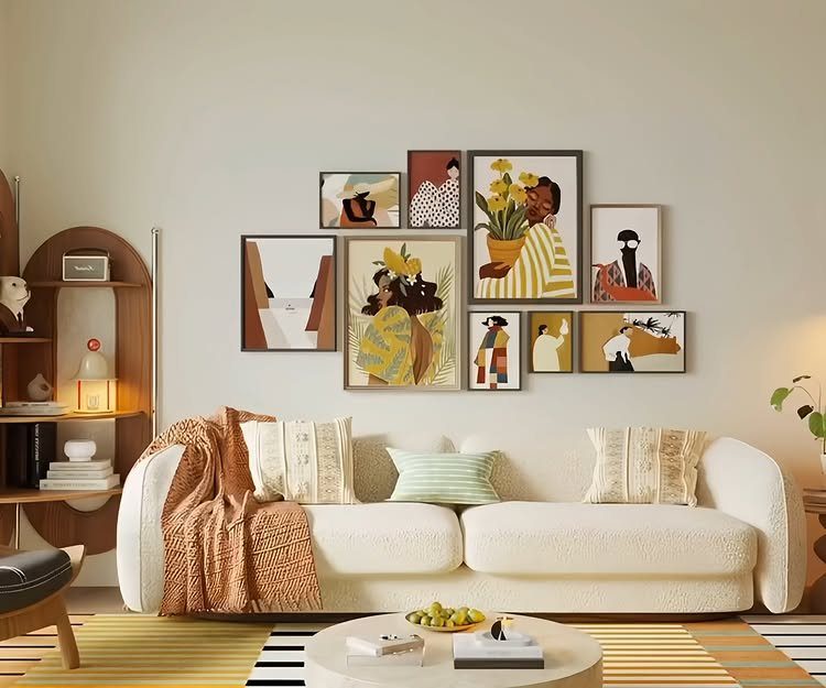 Gallery wall with abstract art frames hanging above a white textured sofa