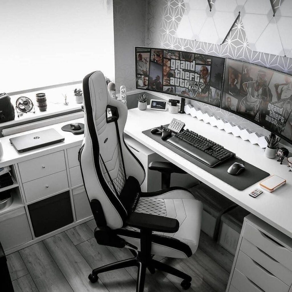 Gaming setup with white desk and black and white chair in monochrome room