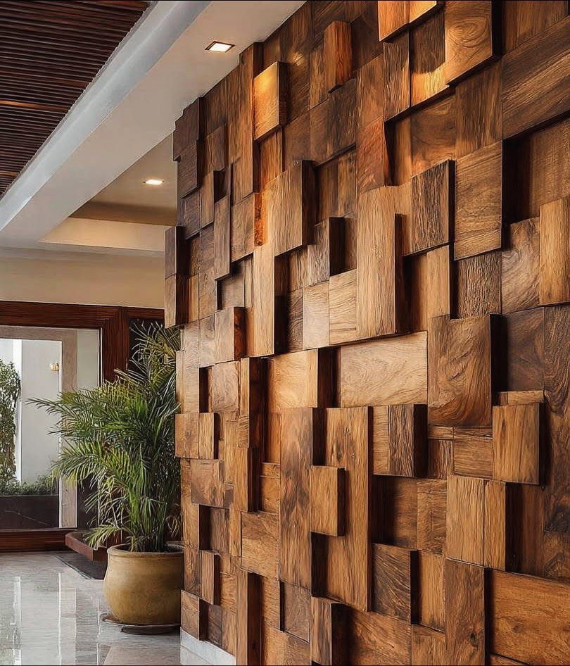 Geometric 3D wood wall panels in a modern interior with a potted plant.